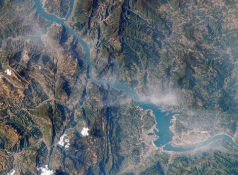 Figure 2. Satellite View of the Three Gorges Dam on the Yangtze River in China and its Reservoir (the Long Narrow Water Body Stretching Upstream) (Nasa Earth Observatory, 2009).